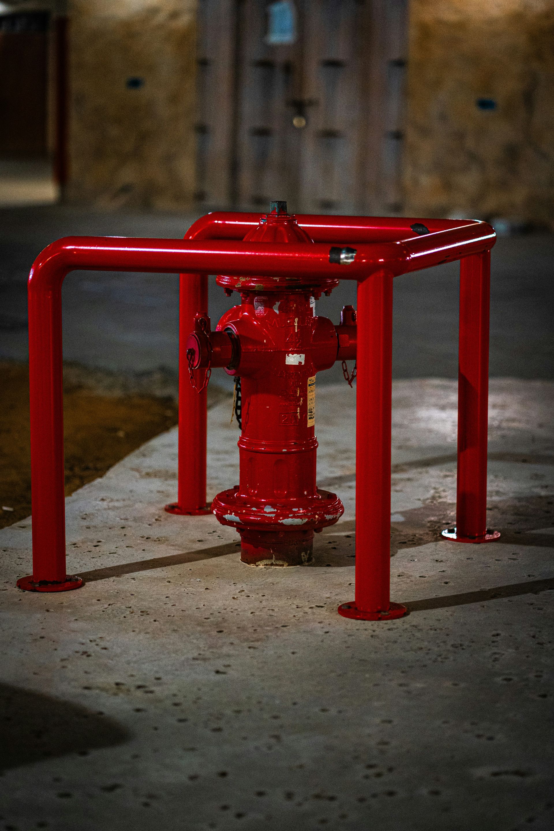 A red fire hydrant sitting on the side of a road